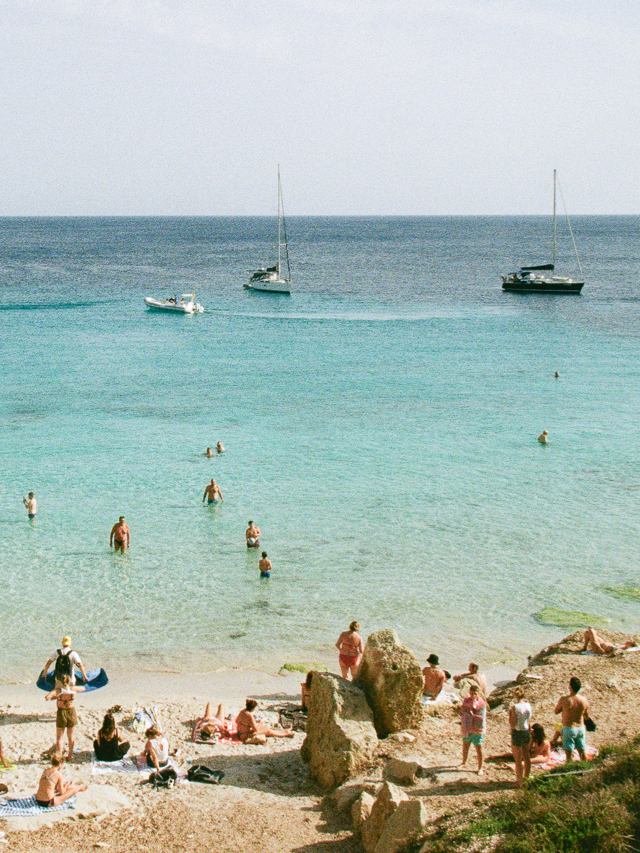Beach scene with people and boats